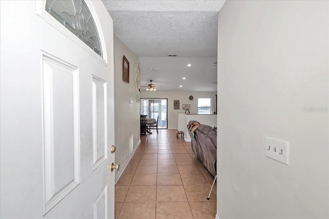 16386 SE 156th Place Rd, Weirsdale, FL 32195 - hallway with light tile patterned flooring, a textured ceiling, recessed lighting, and baseboards