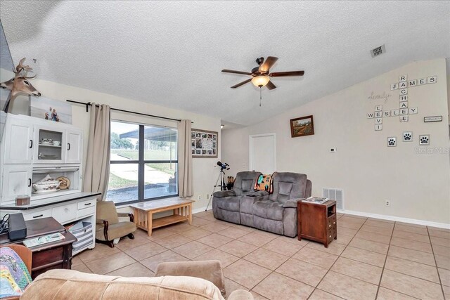 16386 SE 156th Place Rd, Weirsdale, FL 32195 - living area featuring vaulted ceiling, a textured ceiling, ceiling fan, light tile patterned floors, and baseboards