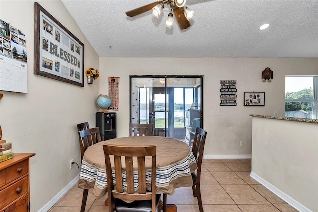16386 SE 156th Place Rd, Weirsdale, FL 32195 - dining area with a textured ceiling, ceiling fan, light tile patterned flooring, and baseboards