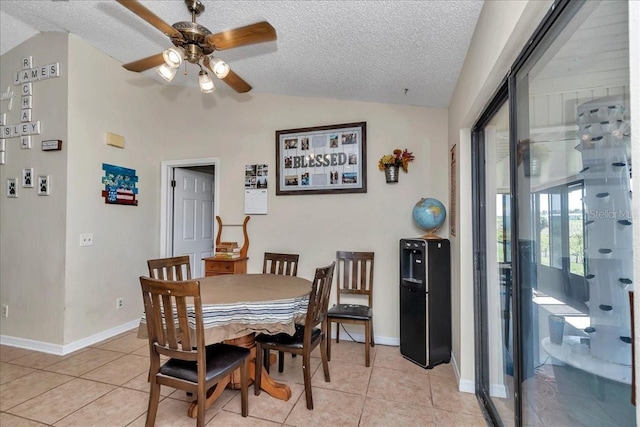 16386 SE 156th Place Rd, Weirsdale, FL 32195 - dining space with vaulted ceiling, a ceiling fan, light tile patterned flooring, baseboards, and a textured ceiling