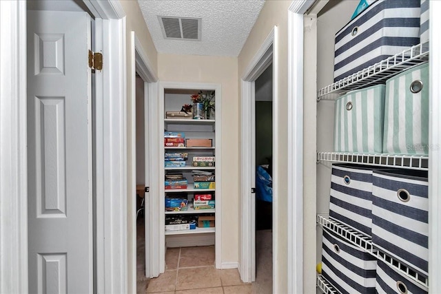 16386 SE 156th Place Rd, Weirsdale, FL 32195 - hallway featuring light tile patterned floors and a textured ceiling