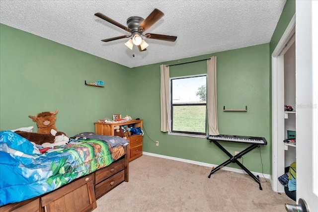 16386 SE 156th Place Rd, Weirsdale, FL 32195 - bedroom with light colored carpet, a textured ceiling, baseboards, and a ceiling fan