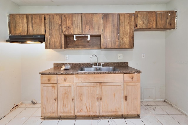 15372 George Blvd, Clearwater, FL 33760 - kitchen featuring under cabinet range hood, a sink, dark countertops, baseboards, and light tile patterned floors