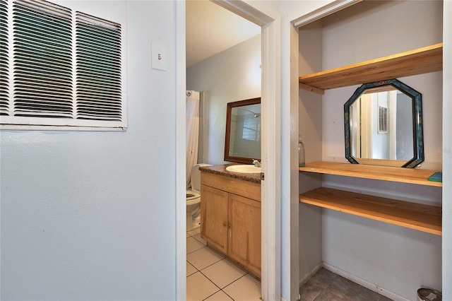 15372 George Blvd, Clearwater, FL 33760 - bathroom with vanity, tile patterned flooring, and toilet