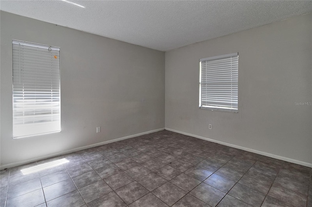 15372 George Blvd, Clearwater, FL 33760 - empty room with a textured ceiling, tile patterned floors, and baseboards