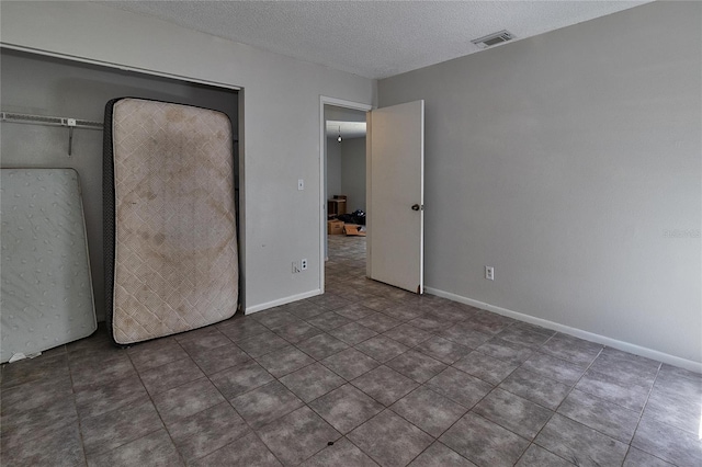 15372 George Blvd, Clearwater, FL 33760 - unfurnished bedroom featuring a textured ceiling, baseboards, and tile patterned floors