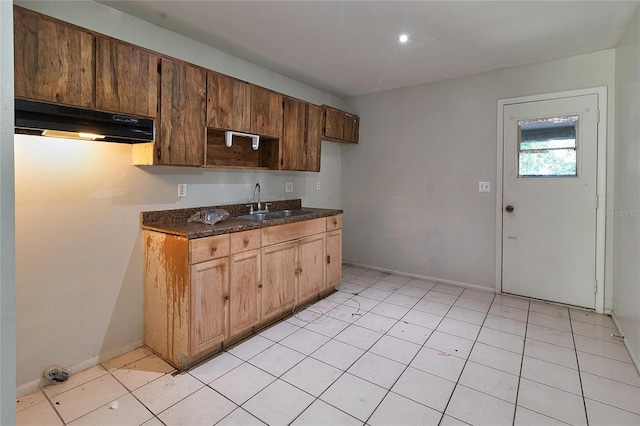 15372 George Blvd, Clearwater, FL 33760 - kitchen featuring under cabinet range hood, dark countertops, a sink, baseboards, and light tile patterned floors