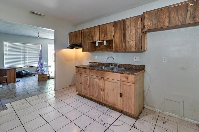15372 George Blvd, Clearwater, FL 33760 - kitchen with a sink, dark countertops, and light tile patterned flooring