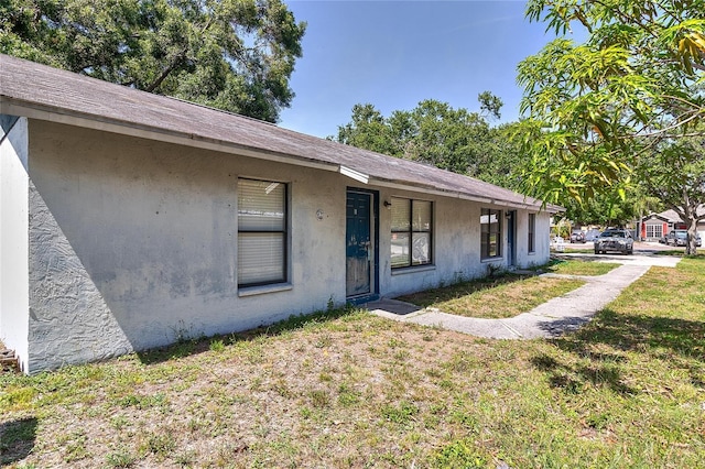 15372 George Blvd, Clearwater, FL 33760 - bungalow featuring stucco siding and a front lawn