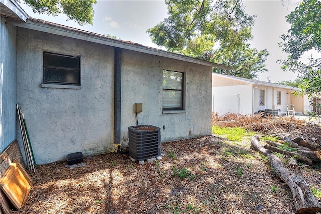 15372 George Blvd, Clearwater, FL 33760 - view of home's exterior featuring central air condition unit and stucco siding