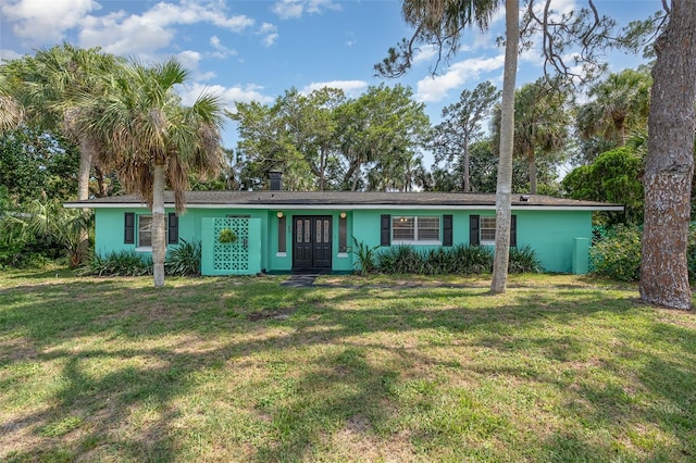 445 Pine Blvd, Merritt Island, FL 32952 - view of front of house with a front yard, stucco siding, and french doors