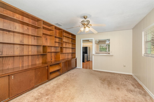 445 Pine Blvd, Merritt Island, FL 32952 - unfurnished room featuring carpet, plenty of natural light, a ceiling fan, and baseboards