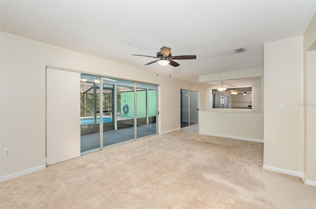 445 Pine Blvd, Merritt Island, FL 32952 - unfurnished living room with carpet flooring, ceiling fan, and baseboards
