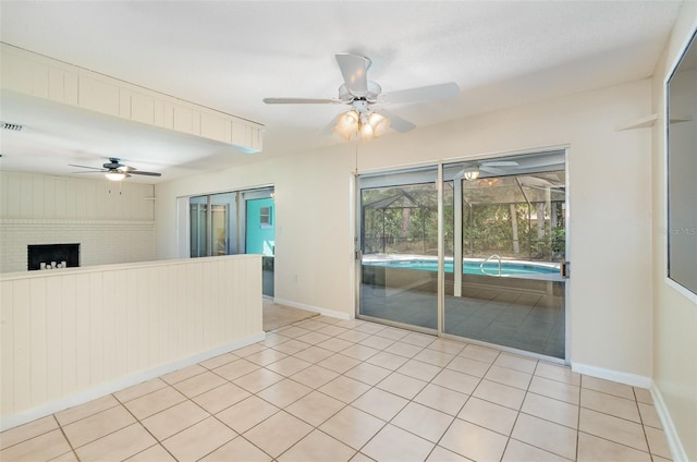445 Pine Blvd, Merritt Island, FL 32952 - spare room featuring ceiling fan, baseboards, a sunroom, and light tile patterned flooring