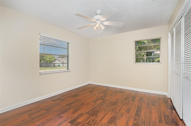 445 Pine Blvd, Merritt Island, FL 32952 - unfurnished bedroom with a closet, dark wood finished floors, baseboards, and a ceiling fan