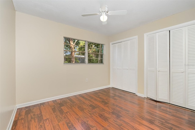 445 Pine Blvd, Merritt Island, FL 32952 - unfurnished bedroom with multiple closets, dark wood finished floors, baseboards, and ceiling fan