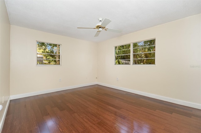 445 Pine Blvd, Merritt Island, FL 32952 - spare room with dark wood finished floors, healthy amount of natural light, and baseboards