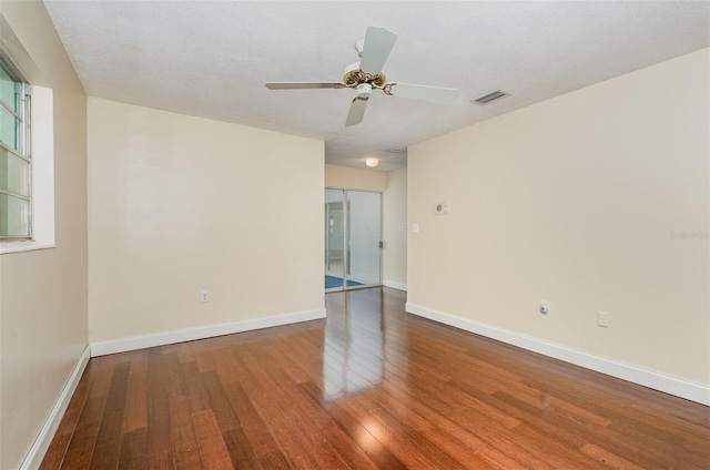 445 Pine Blvd, Merritt Island, FL 32952 - spare room with wood finished floors, a ceiling fan, and baseboards