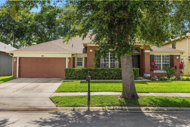 356 Via Tuscany Loop, Lake Mary, FL 32746 - view of front of house with an attached garage, a front lawn, driveway, and stucco siding