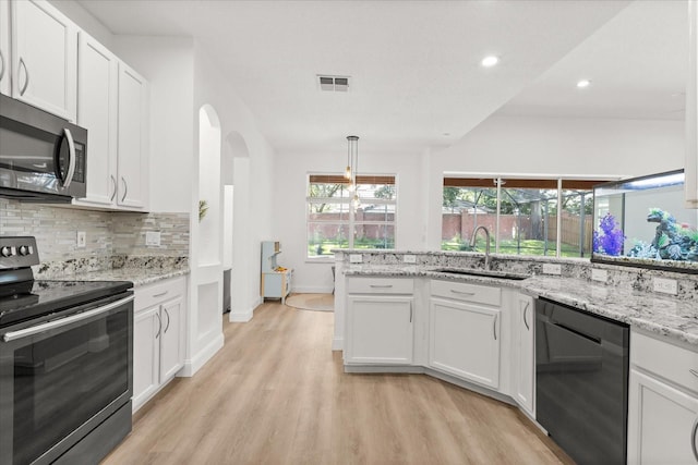356 Via Tuscany Loop, Lake Mary, FL 32746 - kitchen featuring appliances with stainless steel finishes, a sink, light wood-type flooring, white cabinetry, and recessed lighting