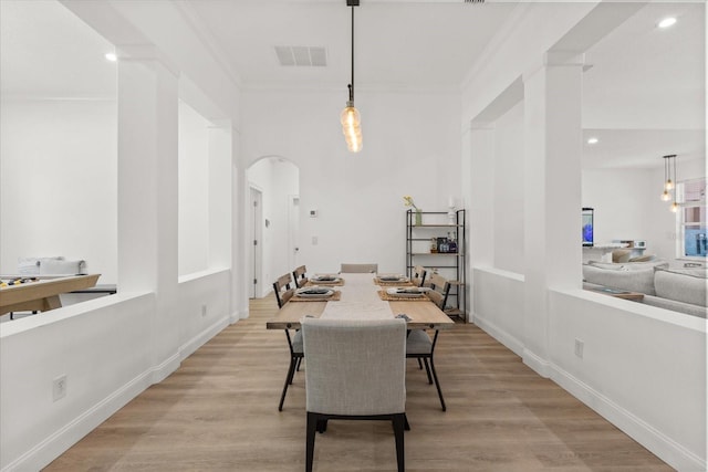 356 Via Tuscany Loop, Lake Mary, FL 32746 - dining area featuring arched walkways, crown molding, light wood-style floors, recessed lighting, and baseboards