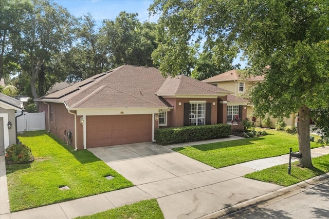 356 Via Tuscany Loop, Lake Mary, FL 32746 - view of front of home with an attached garage, stucco siding, a shingled roof, and concrete driveway