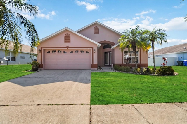 2481 Deer Creek Blvd, Saint Cloud, FL 34772 - ranch-style home featuring stucco siding, an attached garage, driveway, and a front lawn