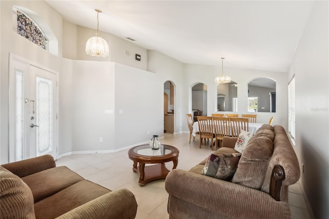 2481 Deer Creek Blvd, Saint Cloud, FL 34772 - living area featuring arched walkways, a chandelier, light tile patterned floors, and high vaulted ceiling