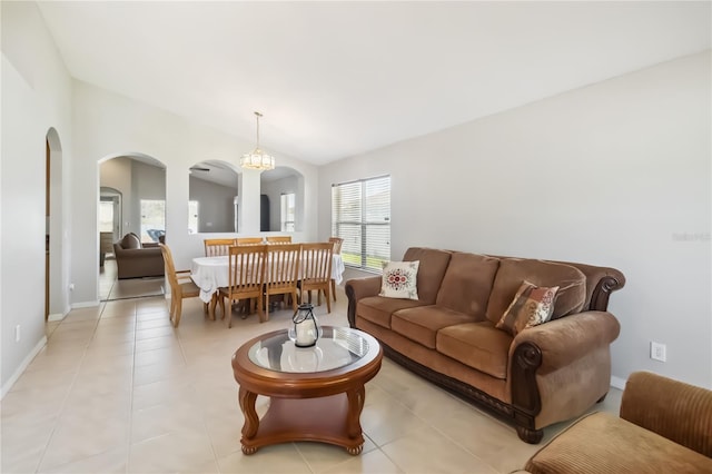 2481 Deer Creek Blvd, Saint Cloud, FL 34772 - living area with arched walkways, a chandelier, light tile patterned floors, and baseboards
