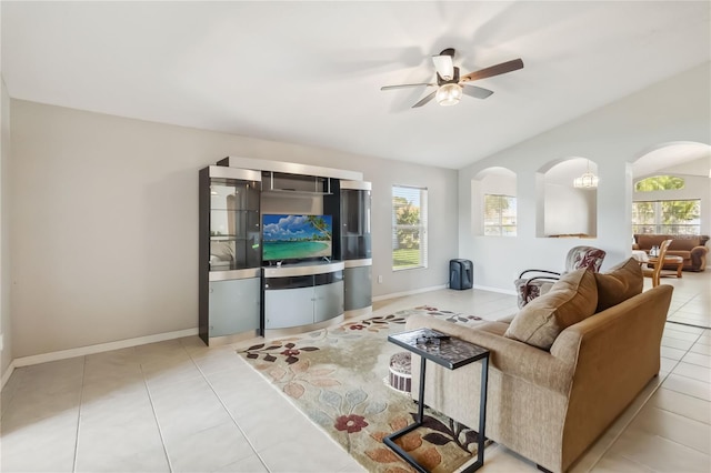 2481 Deer Creek Blvd, Saint Cloud, FL 34772 - living area with ceiling fan, vaulted ceiling, arched walkways, tile patterned flooring, and baseboards