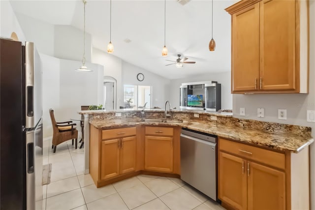 2481 Deer Creek Blvd, Saint Cloud, FL 34772 - kitchen featuring appliances with stainless steel finishes, a sink, vaulted ceiling, light stone countertops, and a peninsula