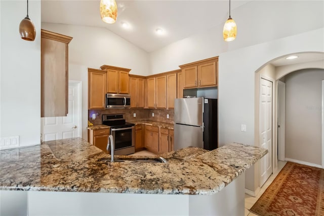 2481 Deer Creek Blvd, Saint Cloud, FL 34772 - kitchen featuring appliances with stainless steel finishes, arched walkways, a peninsula, light stone counters, and decorative backsplash