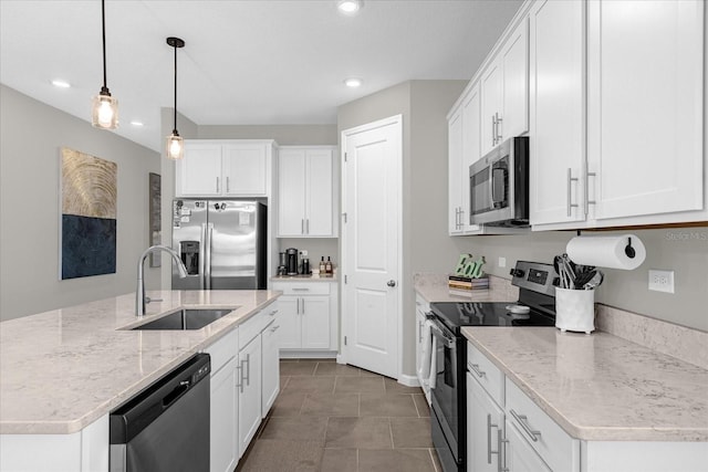 284 White Heron Way, Saint Cloud, FL 34772 - kitchen featuring appliances with stainless steel finishes, a sink, white cabinets, decorative light fixtures, and recessed lighting