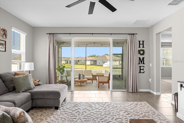 284 White Heron Way, Saint Cloud, FL 34772 - living room featuring a ceiling fan, tile patterned flooring, and baseboards