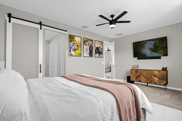 284 White Heron Way, Saint Cloud, FL 34772 - bedroom featuring carpet flooring, a barn door, baseboards, and a ceiling fan