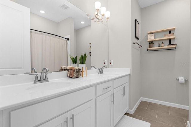 284 White Heron Way, Saint Cloud, FL 34772 - bathroom featuring baseboards, double vanity, a chandelier, tile patterned flooring, and recessed lighting