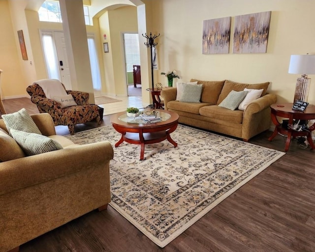 236 Boxwood Dr, Davenport, FL 33837 - living room featuring arched walkways, wood finished floors, and baseboards