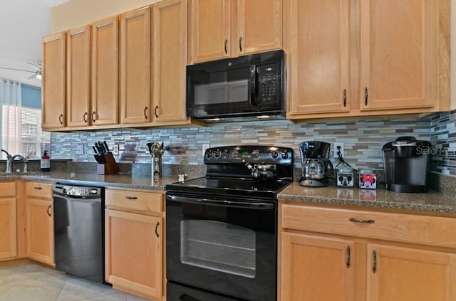 236 Boxwood Dr, Davenport, FL 33837 - kitchen with black appliances, backsplash, dark stone countertops, a sink, and light tile patterned floors