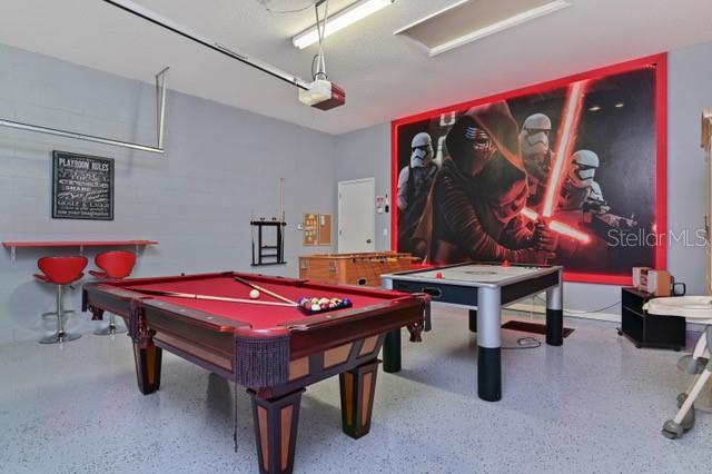 236 Boxwood Dr, Davenport, FL 33837 - playroom featuring speckled floor, billiards table, and a garage