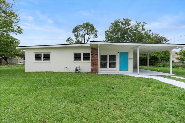 5115 W Livingston St, Orlando, FL 32811 - view of front of property with a front yard, a carport, and driveway