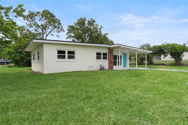 5115 W Livingston St, Orlando, FL 32811 - view of front of home featuring a front yard, a carport, and driveway