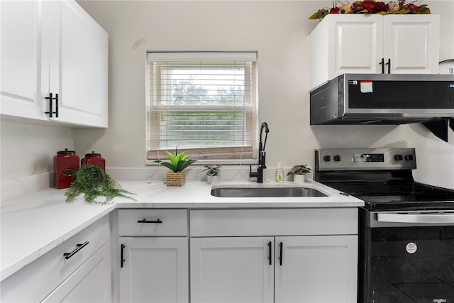 5115 W Livingston St, Orlando, FL 32811 - kitchen with stainless steel appliances, white cabinets, and light countertops