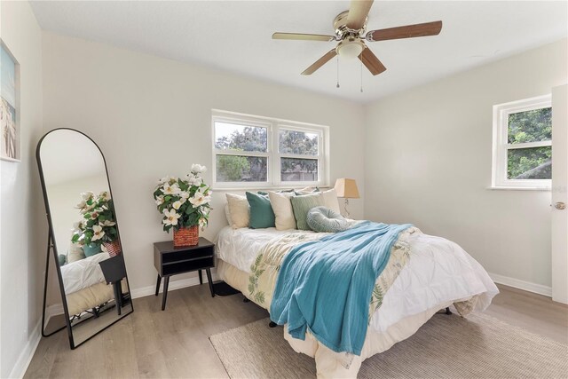 5115 W Livingston St, Orlando, FL 32811 - bedroom with multiple windows, light wood-style flooring, and ceiling fan