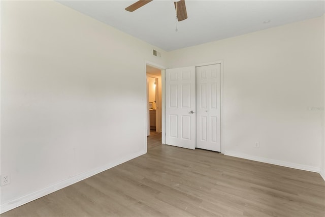 5115 W Livingston St, Orlando, FL 32811 - unfurnished bedroom featuring light wood-type flooring, a closet, and a ceiling fan