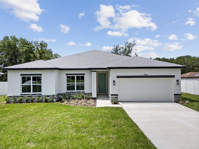 3944 SW 130th Loop, Ocala, FL 34473 - prairie-style house featuring stucco siding, a garage, concrete driveway, and roof with shingles