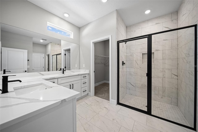 3944 SW 130th Loop, Ocala, FL 34473 - full bathroom featuring marble look tile flooring, a shower stall, double vanity, a spacious closet, and baseboards