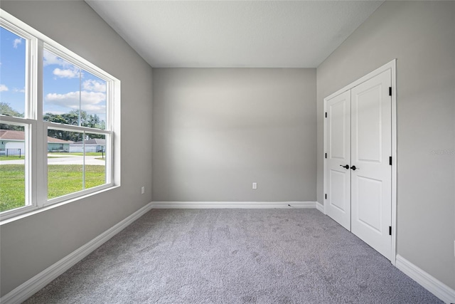 3944 SW 130th Loop, Ocala, FL 34473 - unfurnished bedroom with carpet flooring, baseboards, and a closet