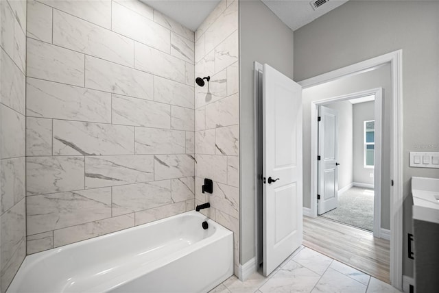 3944 SW 130th Loop, Ocala, FL 34473 - full bathroom featuring marble look tile flooring, shower / bathtub combination, baseboards, and vanity