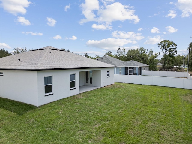 3944 SW 130th Loop, Ocala, FL 34473 - back of property featuring stucco siding, roof with shingles, and a patio