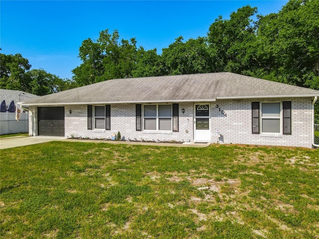 3104 Lime Tree Dr, Edgewater, FL 32141 - single story home featuring an attached garage, driveway, brick siding, and a front lawn